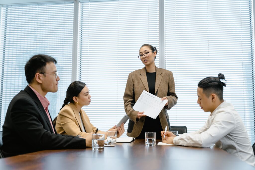 Sales manager leading a team discussion focused on problem-solving, communication, and leadership development